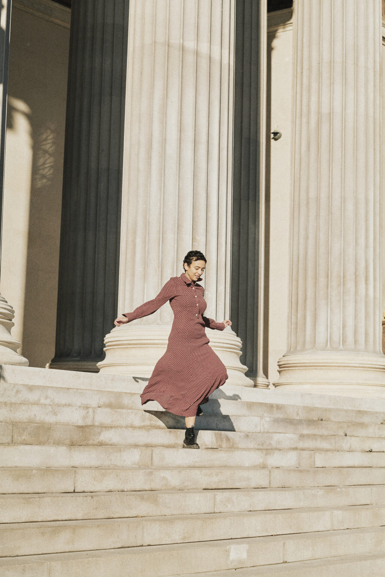 Eine Frau läuft die Stufen des wiener Parlaments hinunter